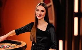 Live casino dealer at blackjack table
